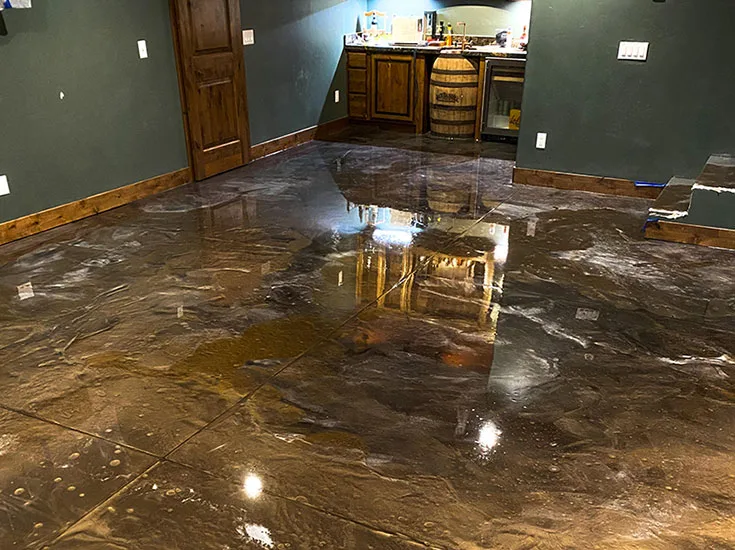 Metallic concrete floor coating with a poured-stone finish