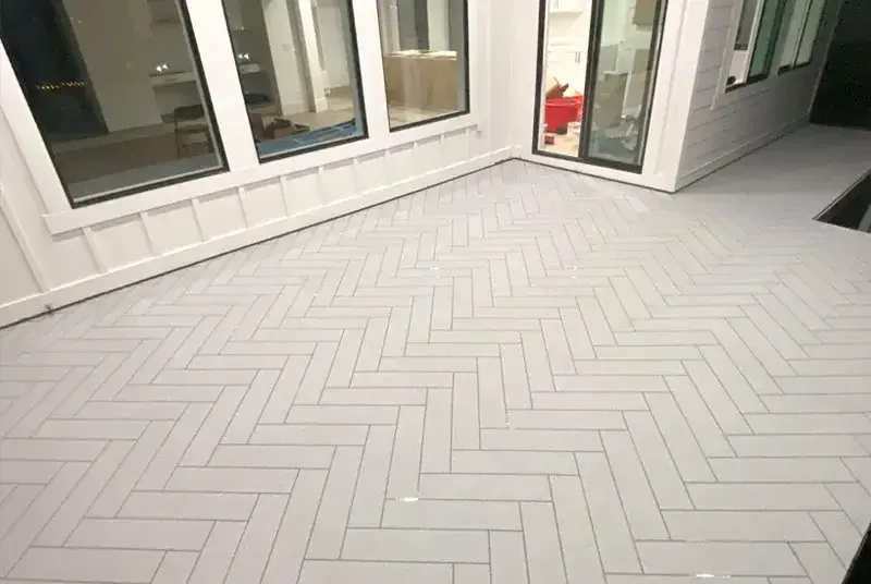 Waterproof coating applied to an exterior deck surface